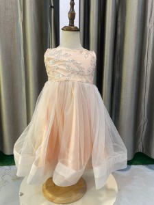 Peach Baby Frock with beaded cheat and fishnet borders